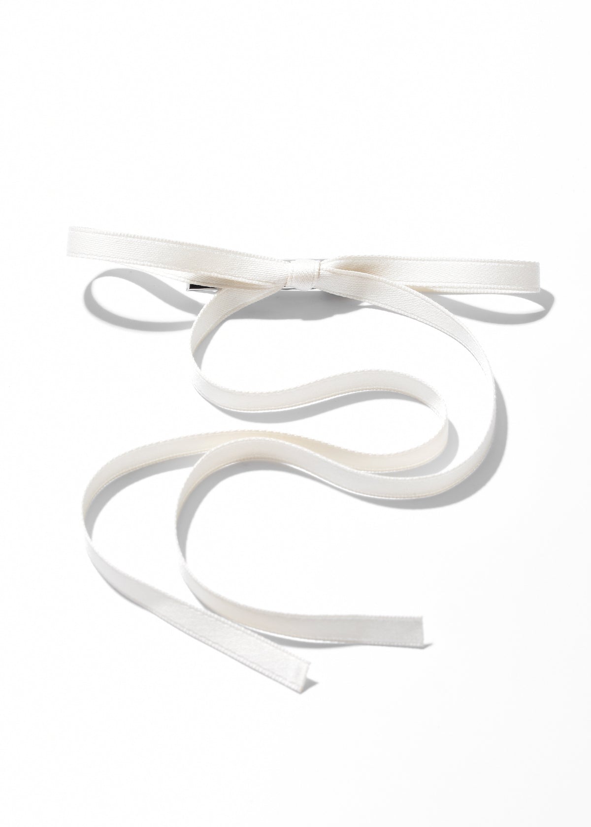 White ribbon hair clip with a bow and long flowing tails