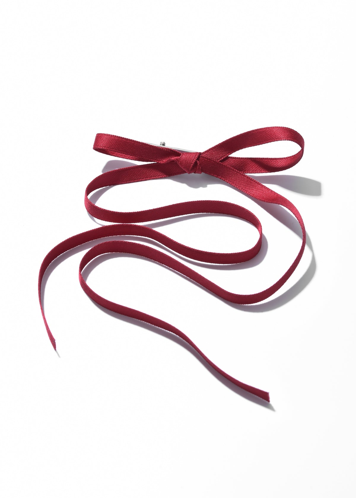 Red ribbon hair clip with a bow and long flowing tails