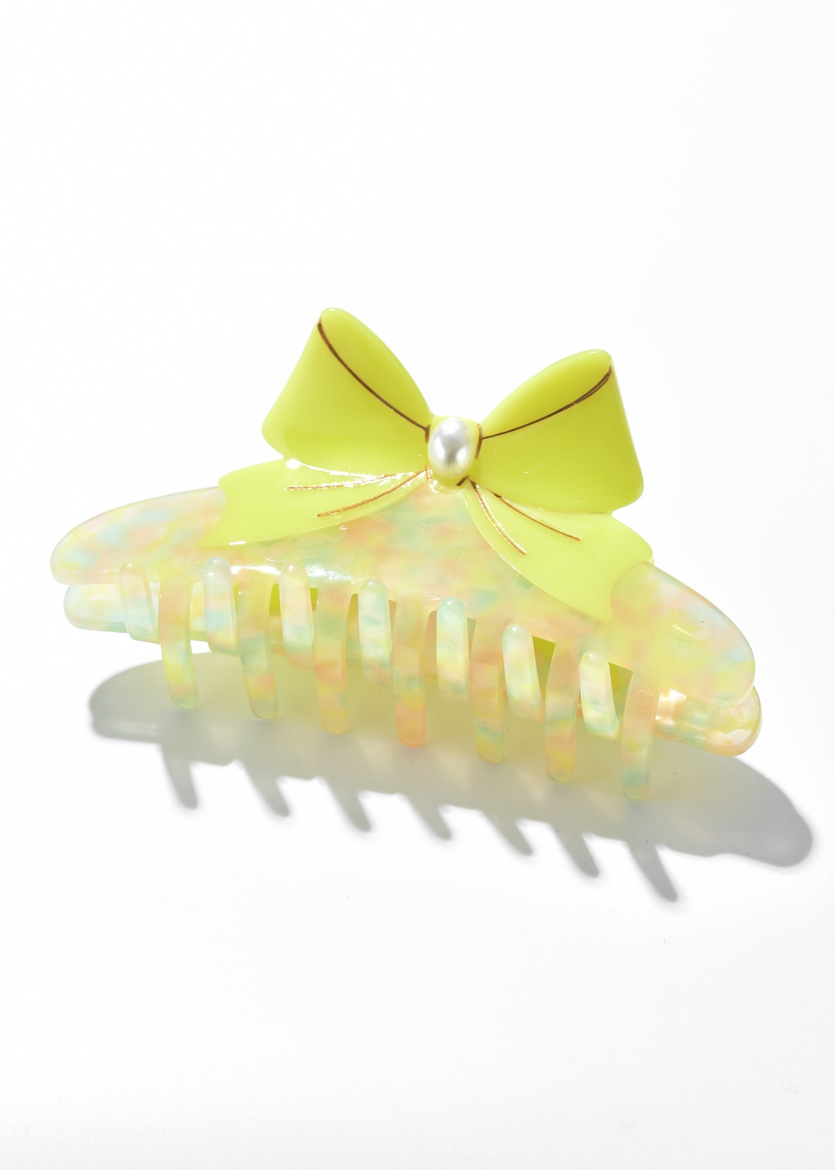 Iridescent claw clip with a bright yellow bow and pearl-like center