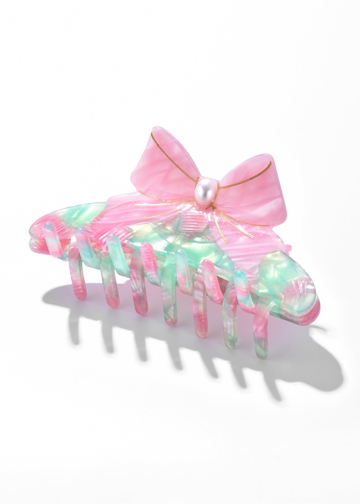 Multicolor iridescent claw clip with a pink bow and pearl-like center
