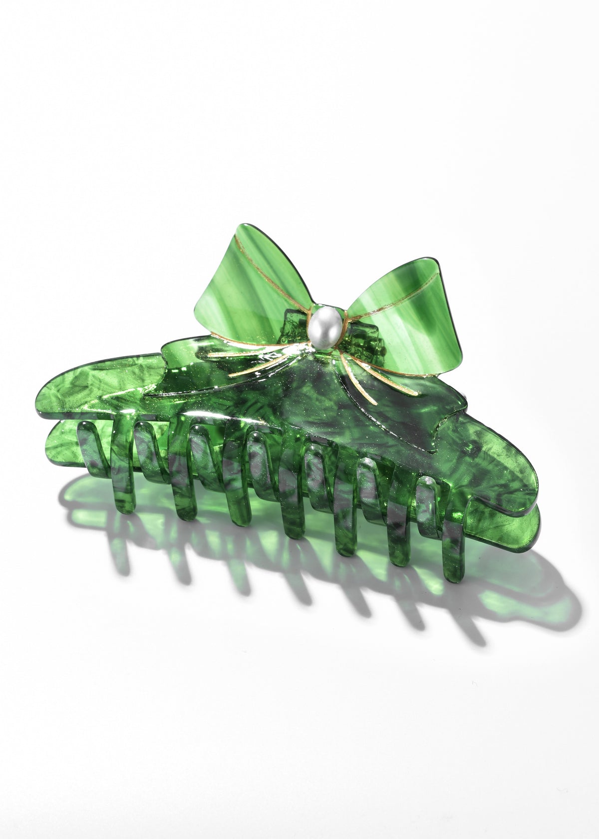 Green translucent claw clip with a matching bow and pearl-like center