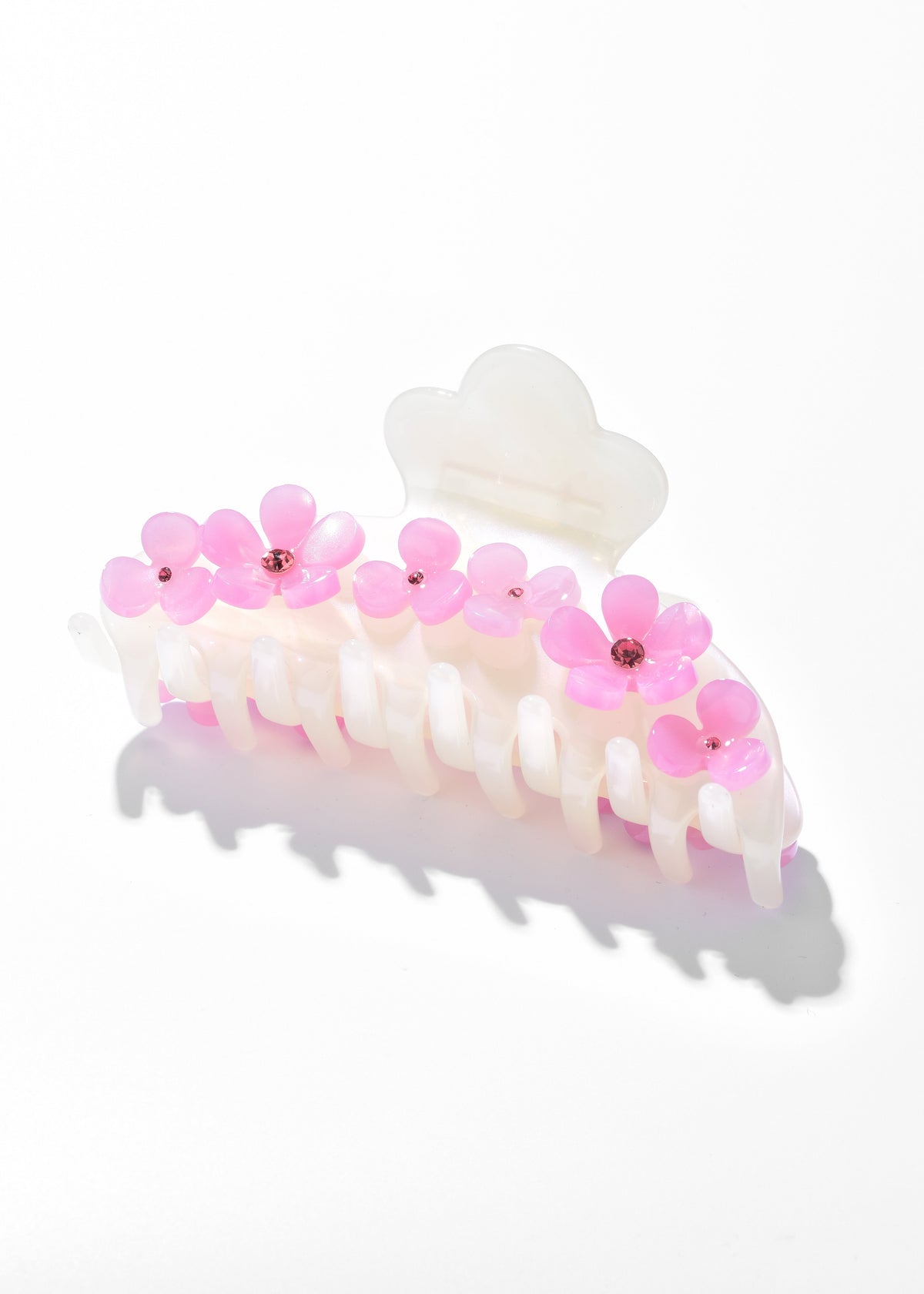 White hair claw decorated with pink flowers and small bead centers