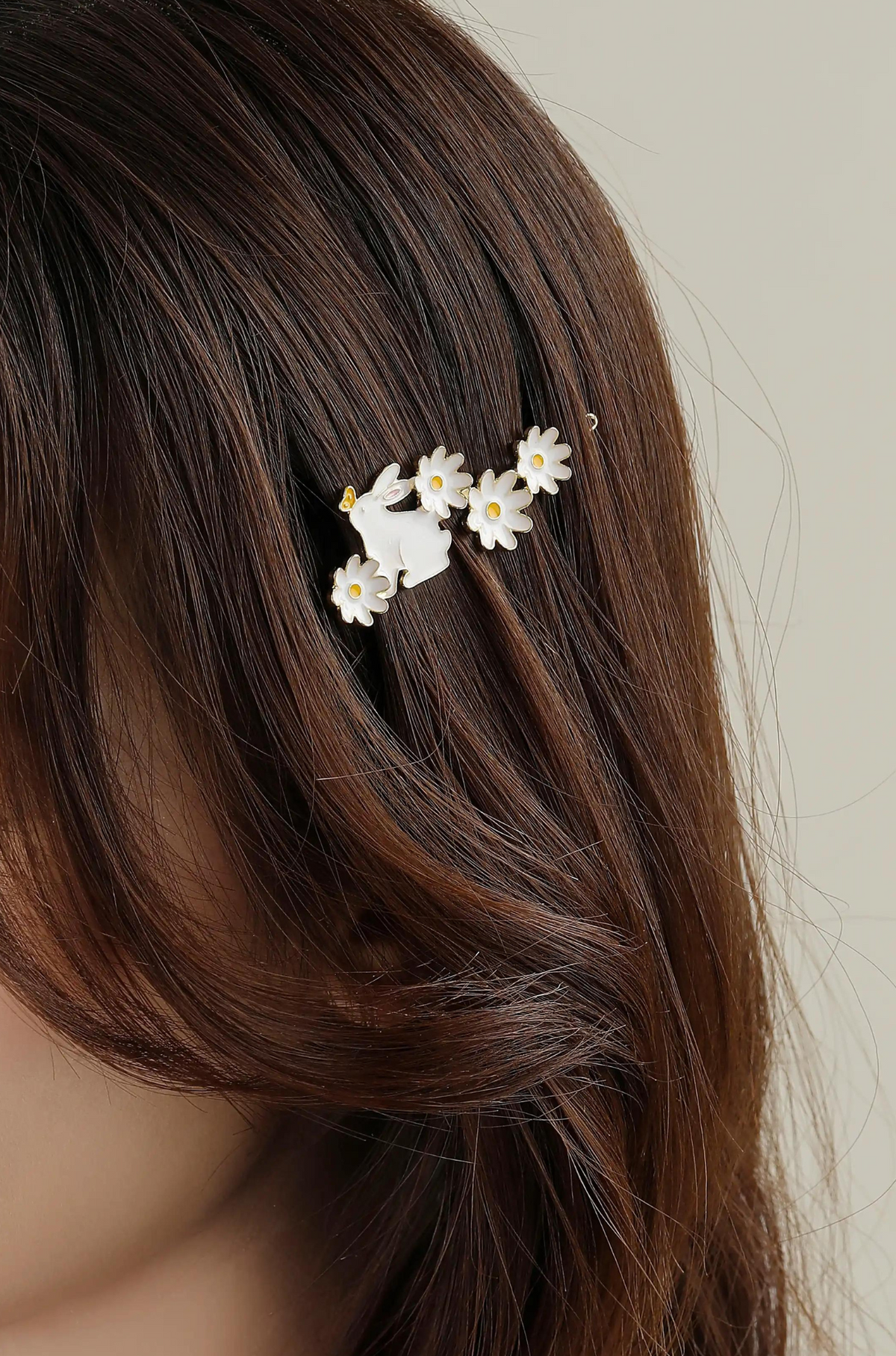 White bunny and daisy hair clip worn in long brown hair