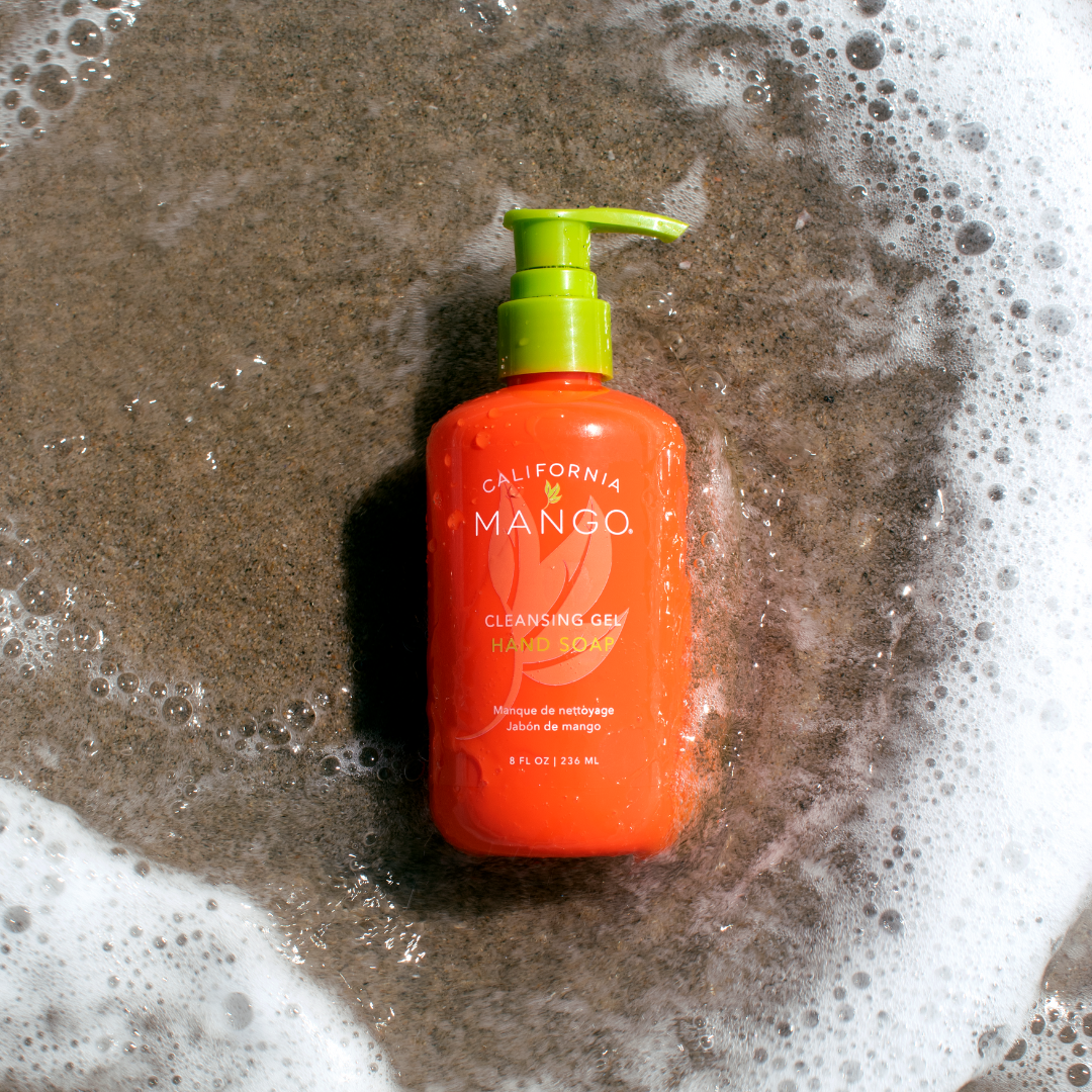 California Mango hand soap bottle with lime green pump, shown among suds