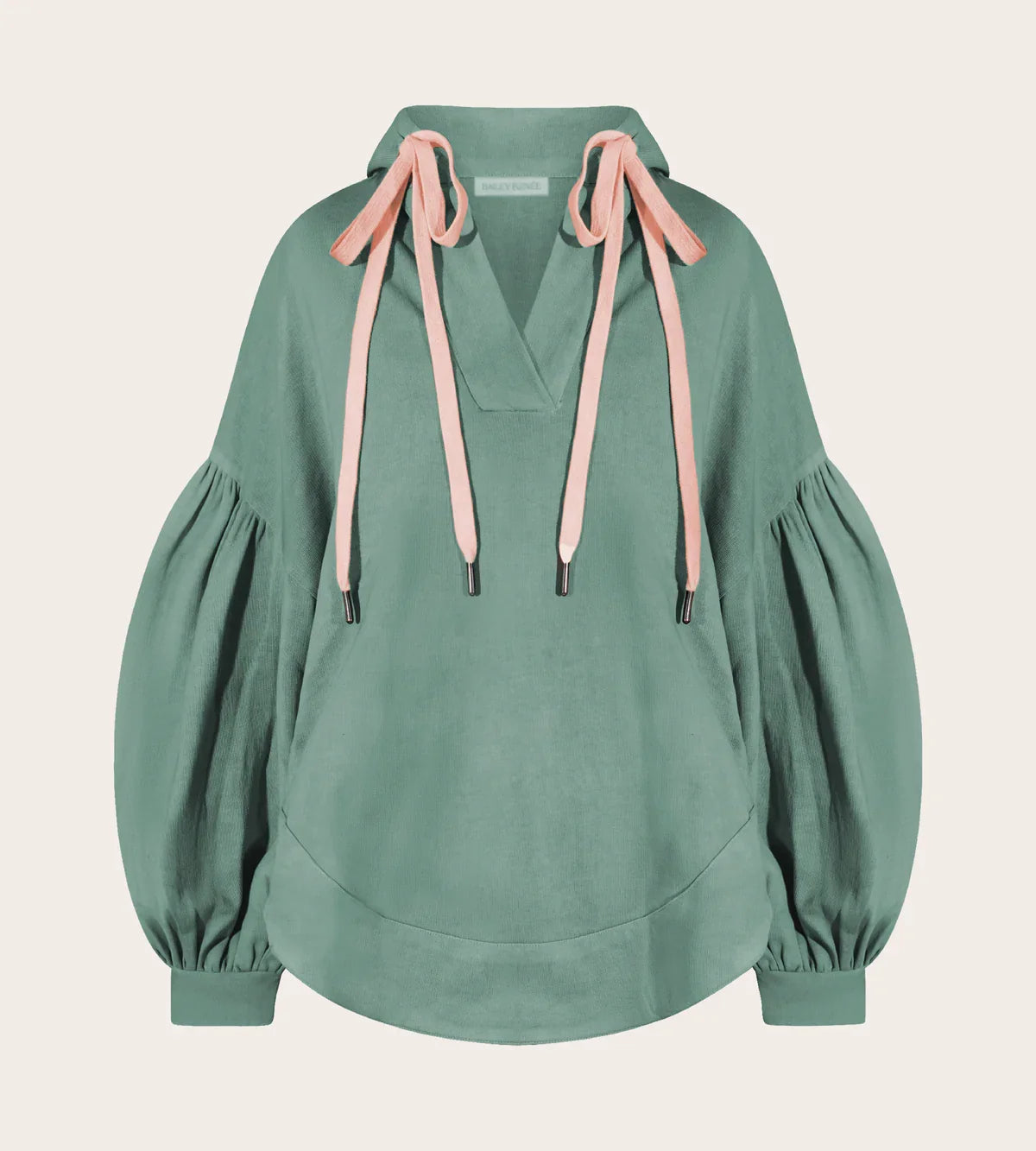 Front view of sage green Harmony Hoodie with pink drawstrings, kangaroo pocket, and balloon sleeves.