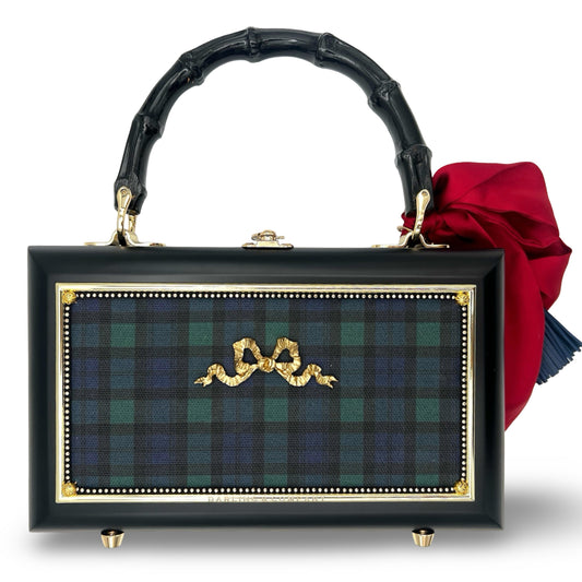Plaid bow handbag with black frame, gold trim, bamboo handles, red bow detail
