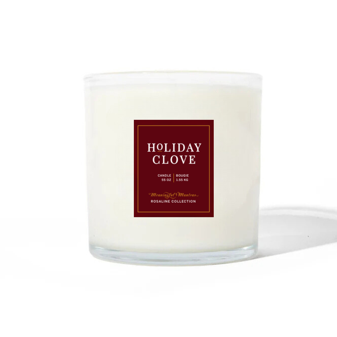 Unlit Holiday Clove candle in a clear glass jar with a red label