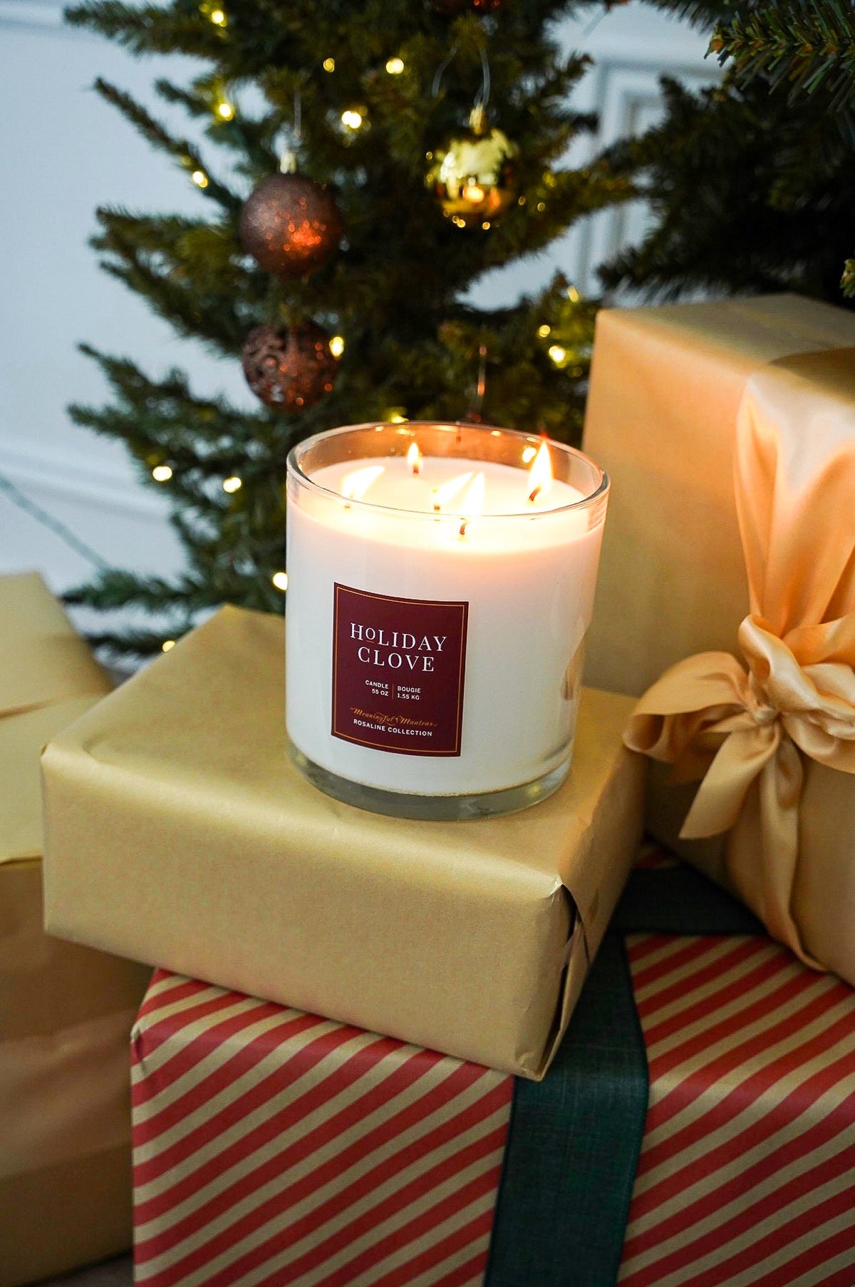 Lit Holiday Clove candle in a clear glass jar