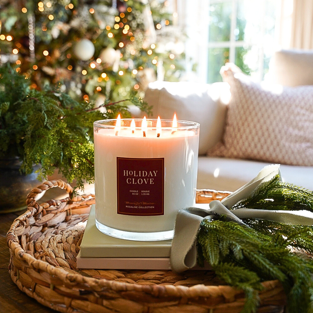 Lit Holiday Clove candle in a glass jar with several wicks