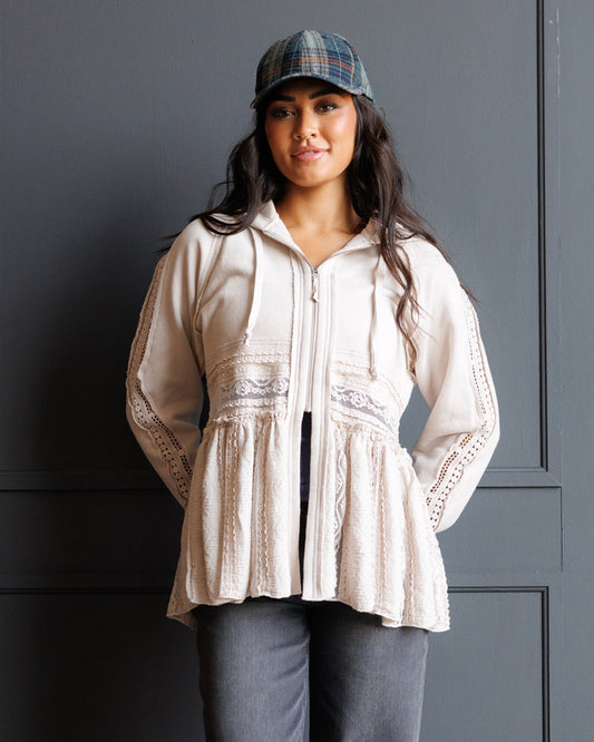 Cream lace-trim hoodie with drawstring, peplum hem, and tiered panels