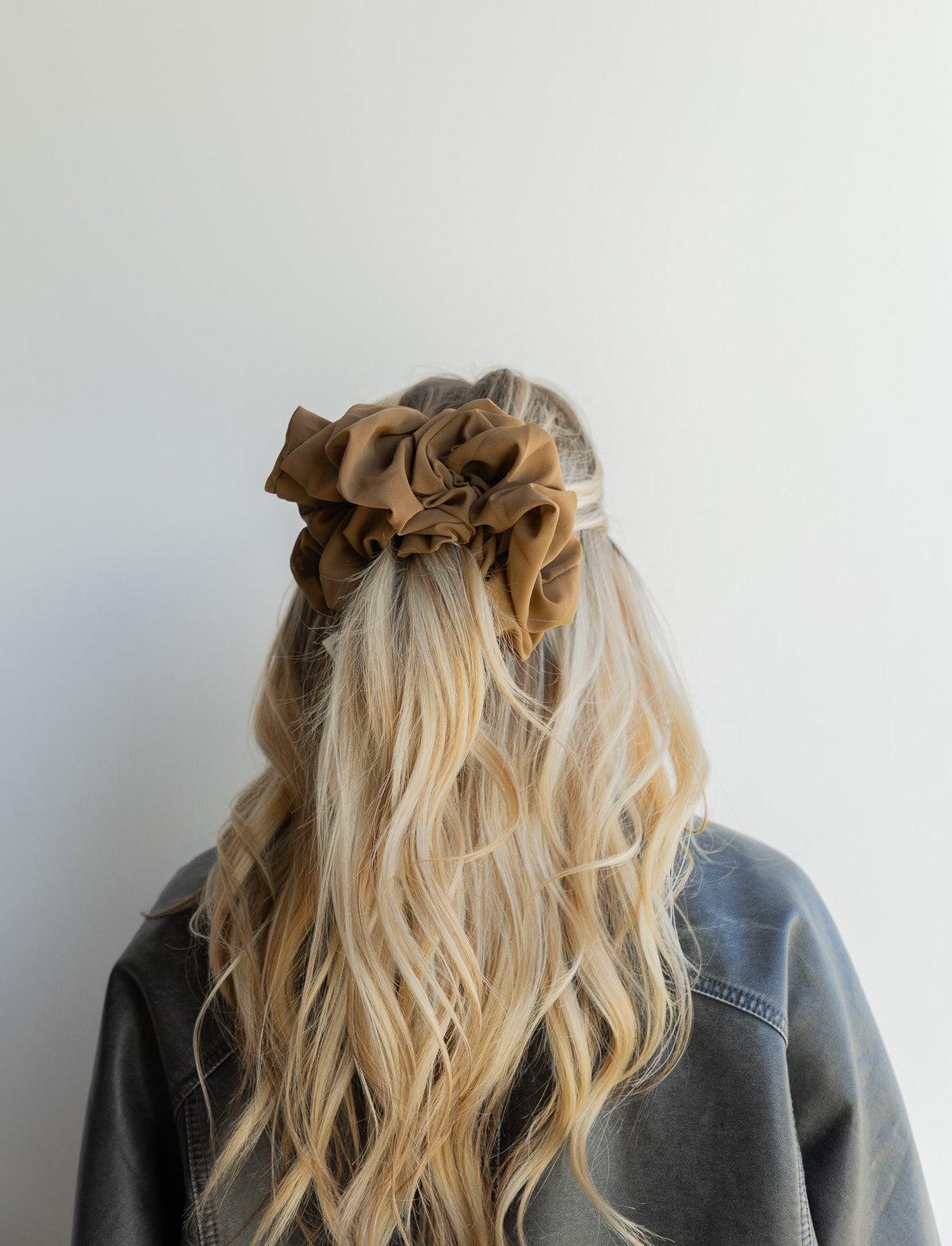 Brown jumbo scrunchie on long blonde hair, large gathered ruffle shape