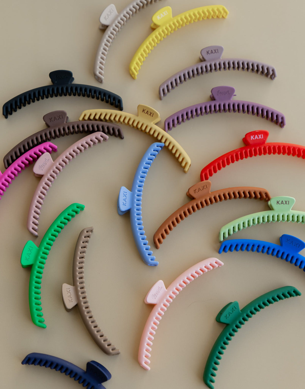 Assorted matte claw hair clips in multiple colors, curved comb teeth, hold-everything style