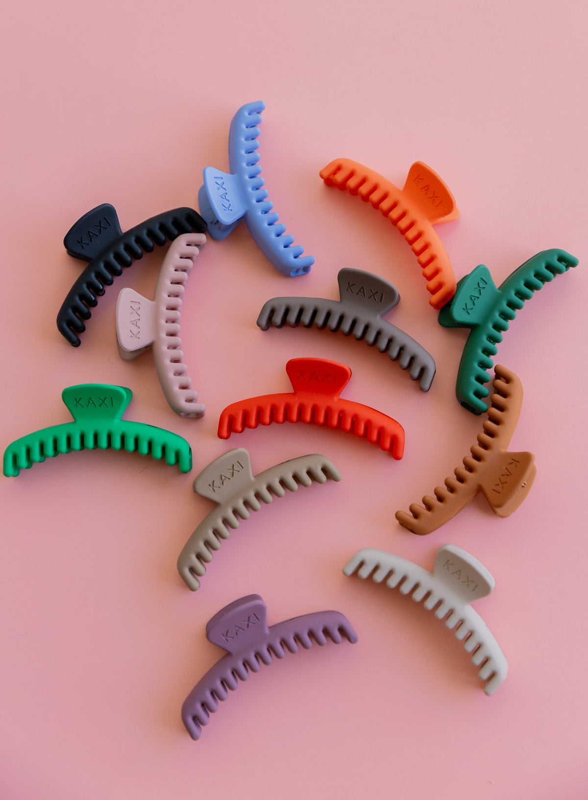 Assorted matte claw hair clips in multiple colors with curved comb teeth.