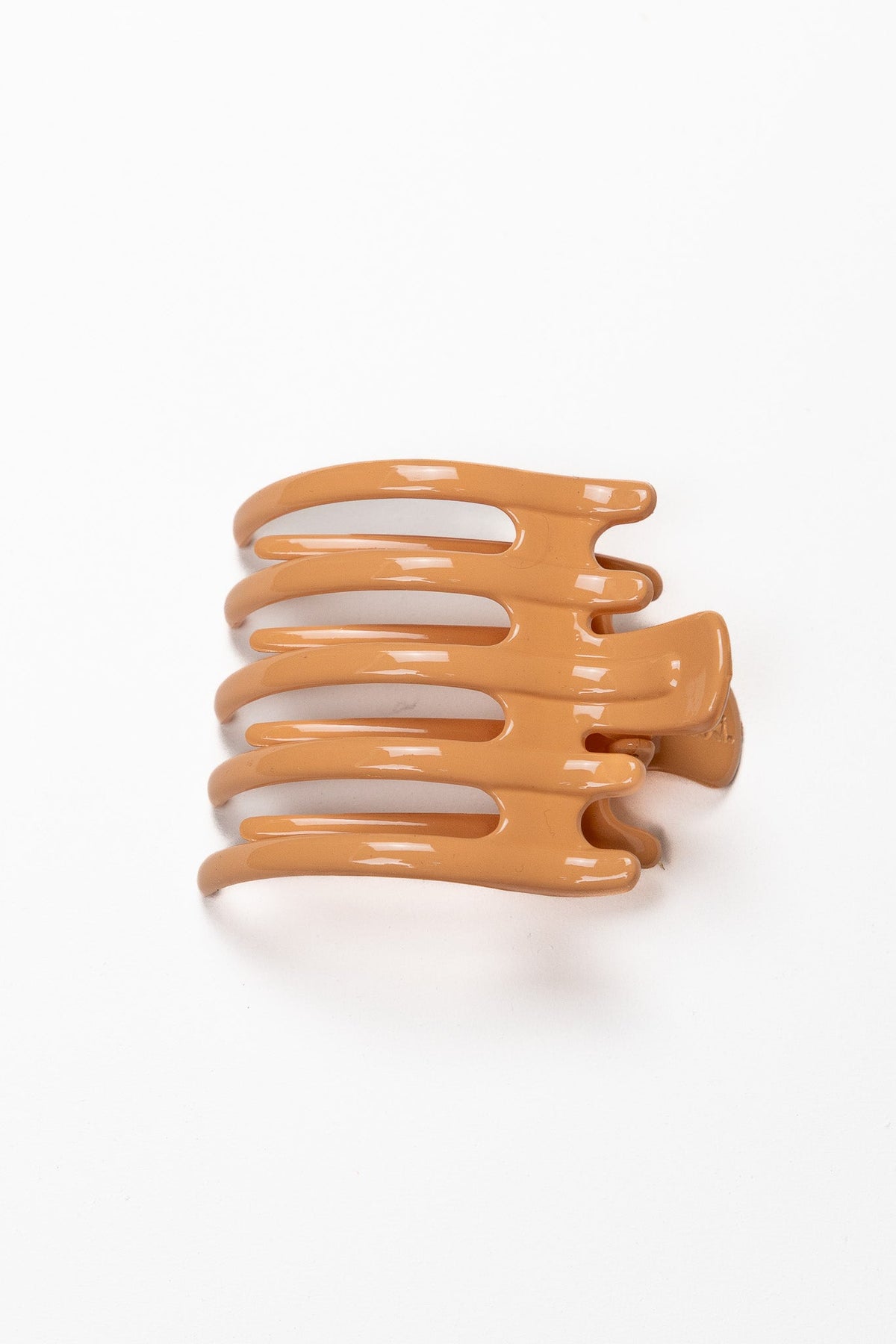 Wide lay-down hair claw, shiny orange with three curved ridges