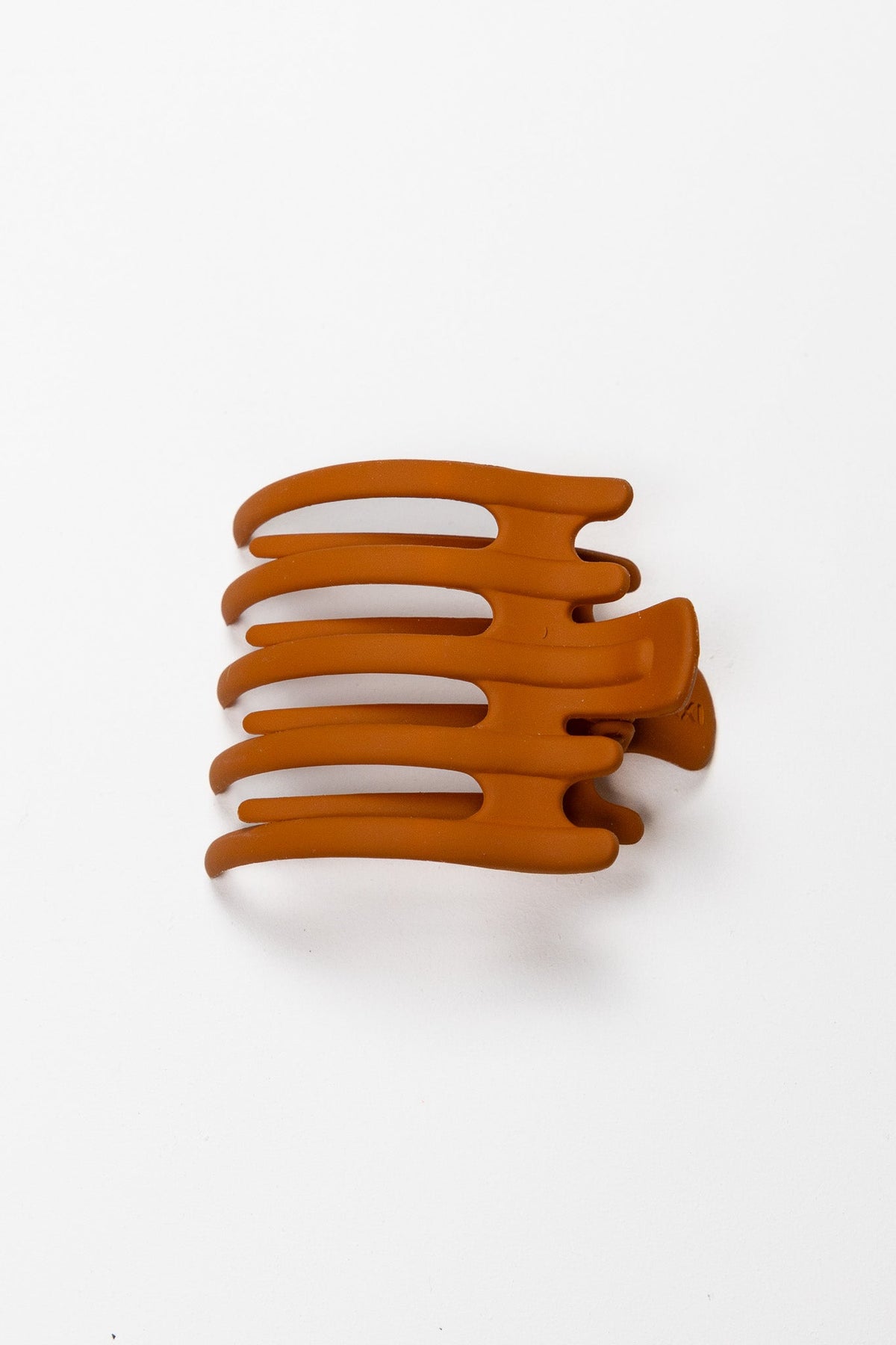 Wide hair claw clip in burnt orange, flat comb-style design