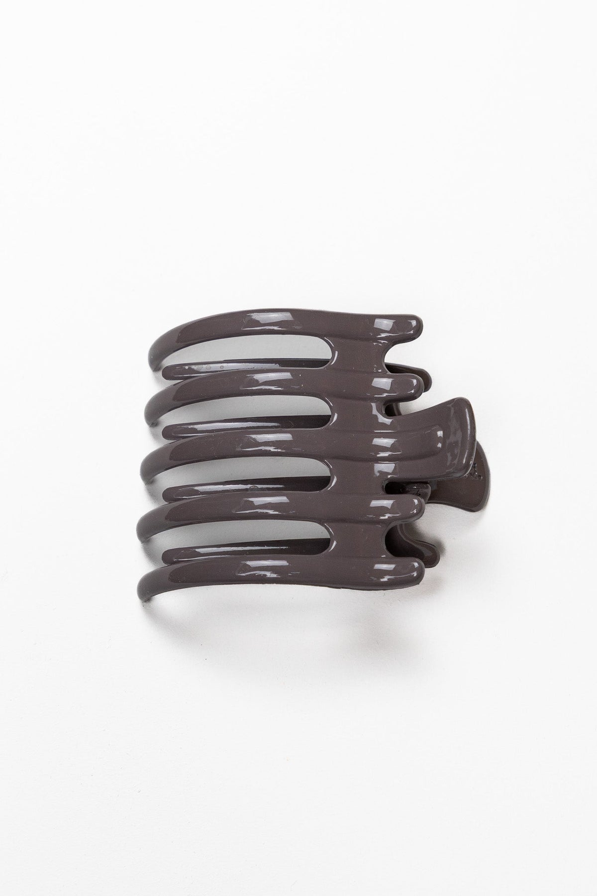 Wide lay down hair claw in shiny dark brown, shown from front.