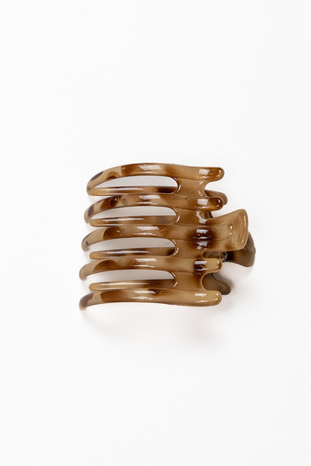 Wide hair claw clip in glossy caramel-brown tortoise tone
