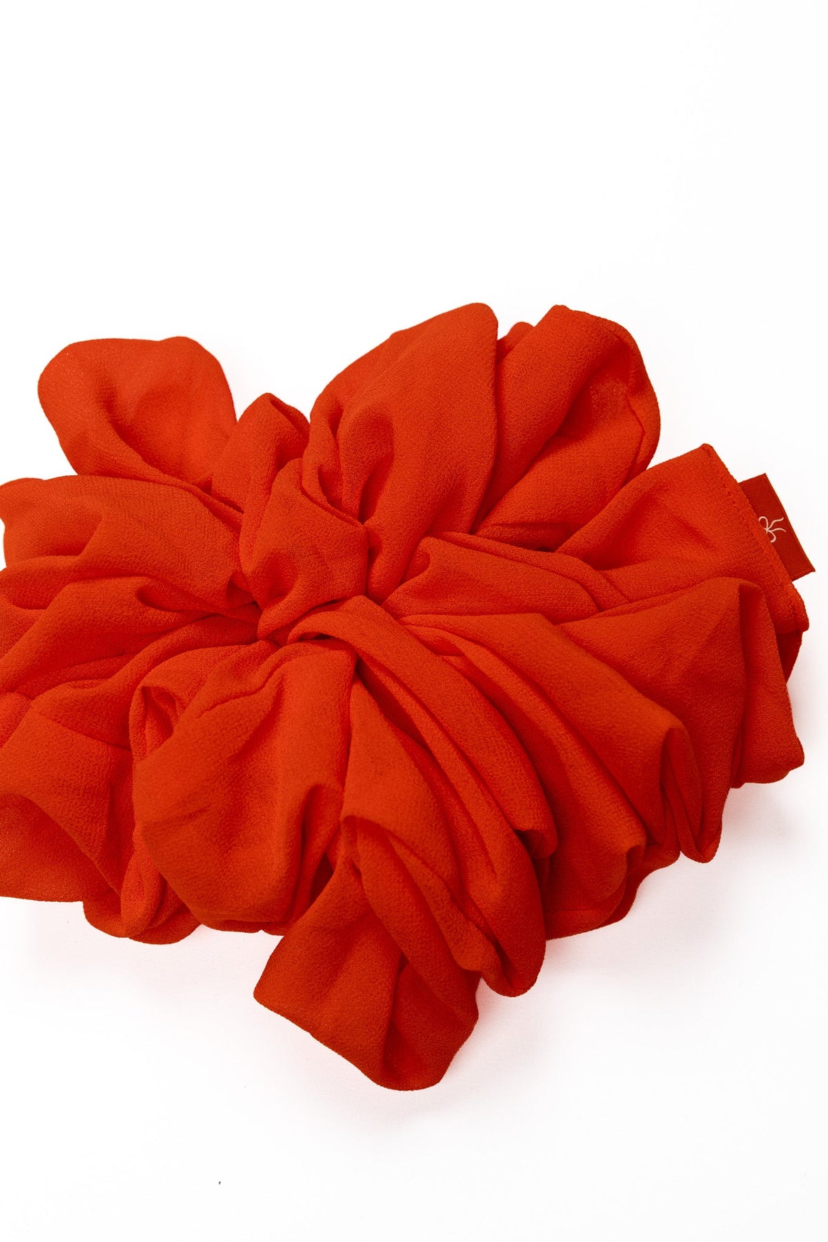 Bright orange jumbo scrunchie with oversized ruched rosette