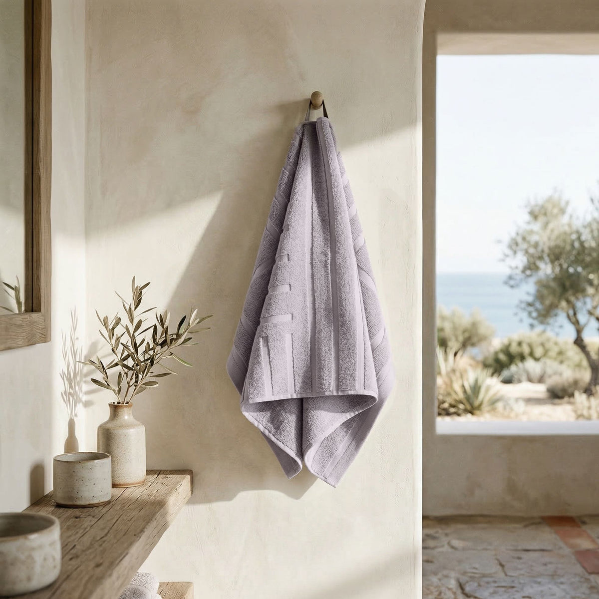 Lavender towel hanging, with vertical stripe texture and soft terry loops.