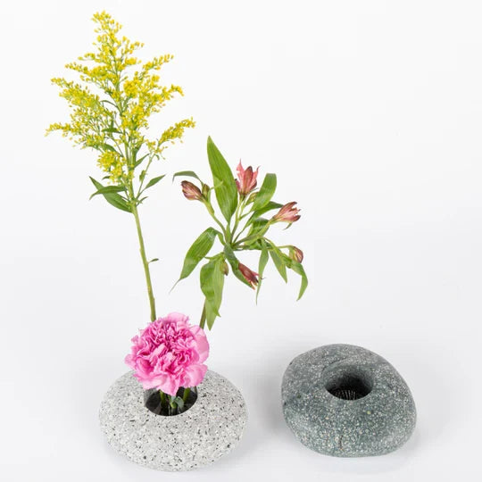 Speckled stone ikebana vase set with dark bowl openings and flower stems