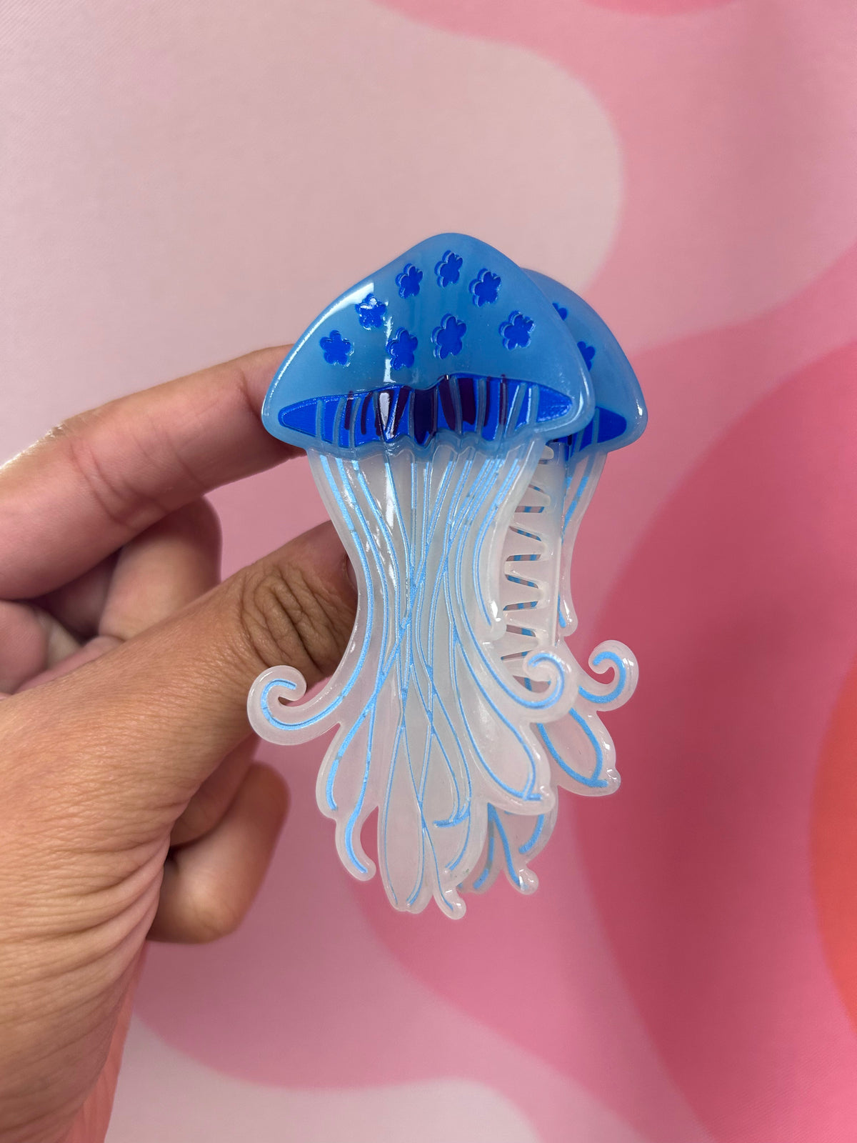 Blue jellyfish hair claw with translucent tentacles and comb teeth