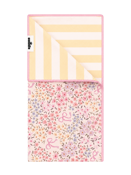 Quick-dry towel with pink floral and flamingo print, folded rectangle