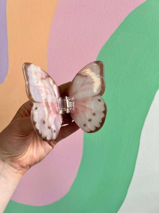 Butterfly hair claw with pink-and-white wings and clear center clasp