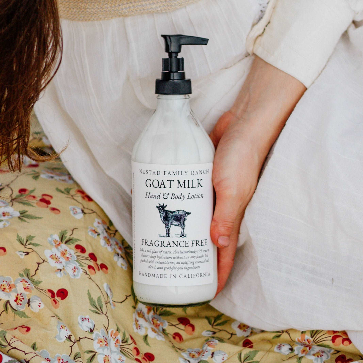 Fragrance-free goat milk hand and body lotion pump bottle, clear-white liquid