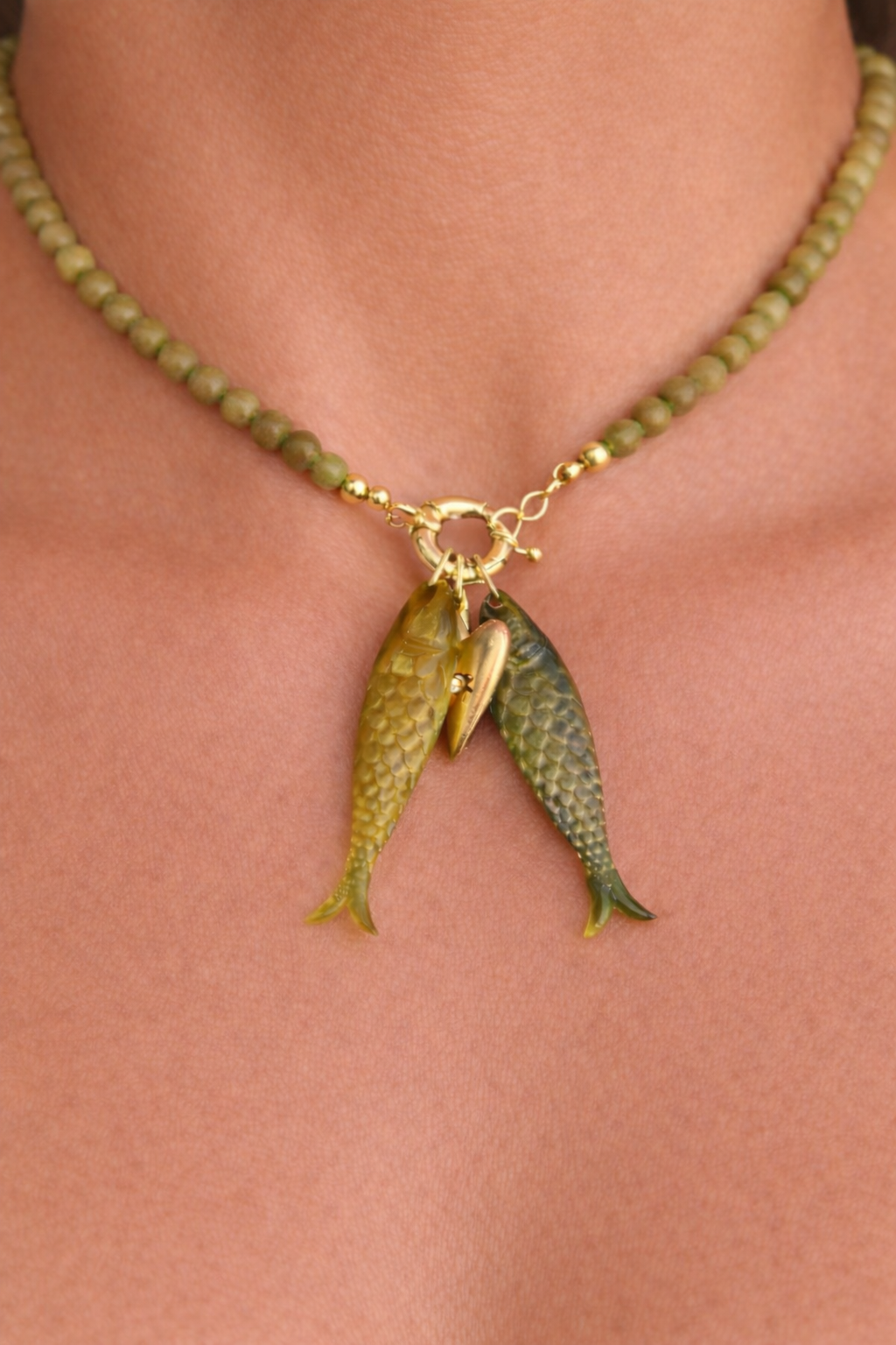 Olive bead fish pendant necklace with textured twin fish charm detail