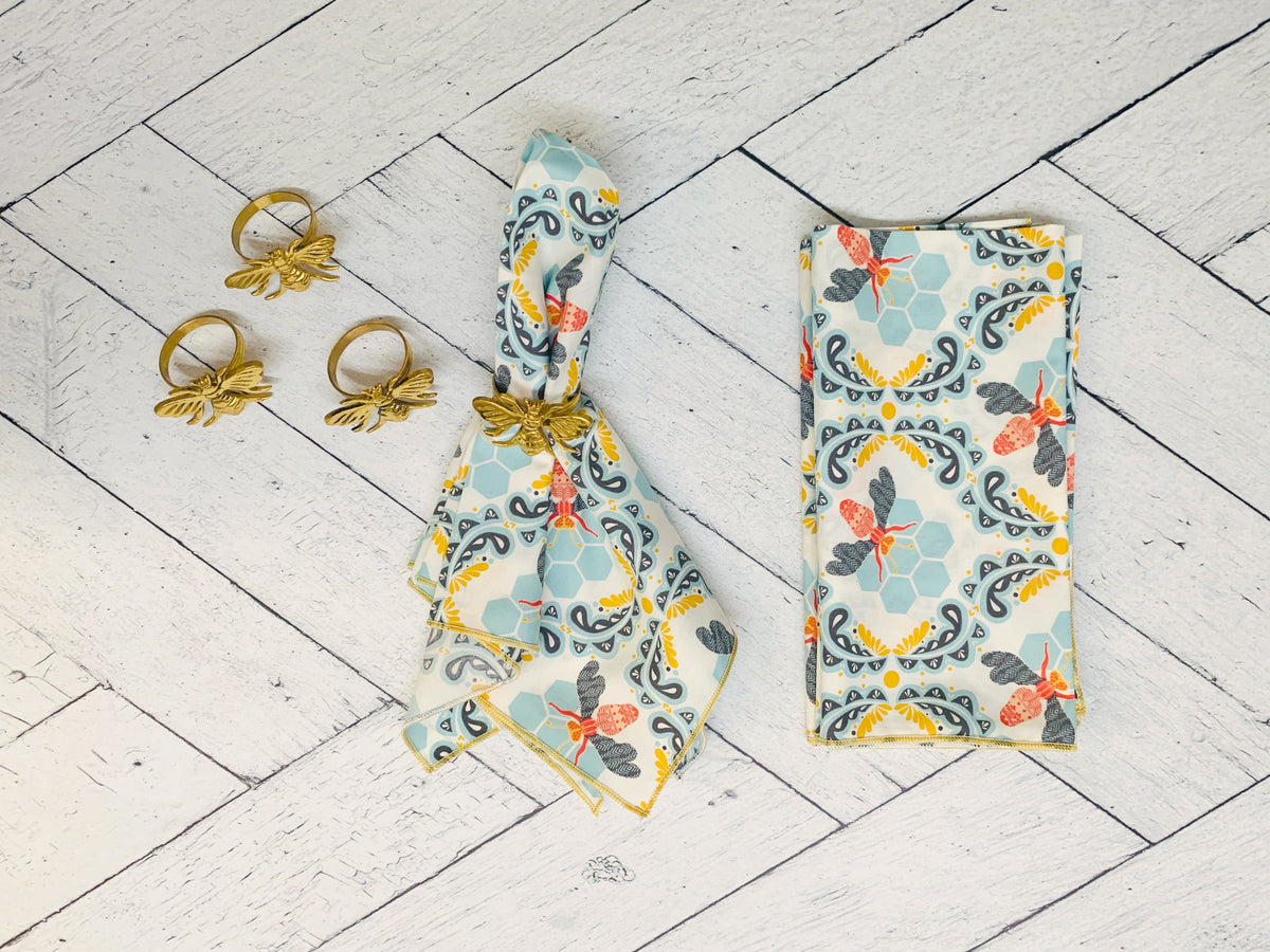 Bee and honeycomb print cloth napkin set of four, light blue with gray and orange accents