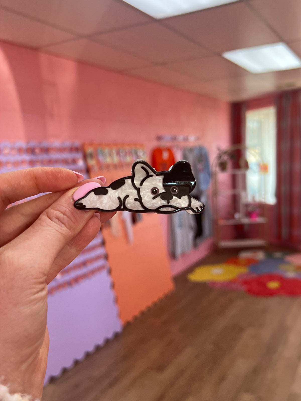 White and black dog lying pet hair claw with outline and curled tail
