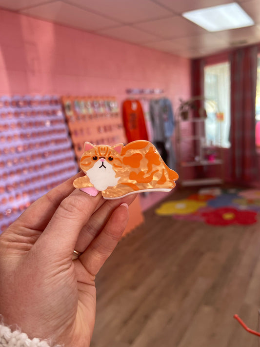 Orange cat face hair claw with curled ears and white cheek patch