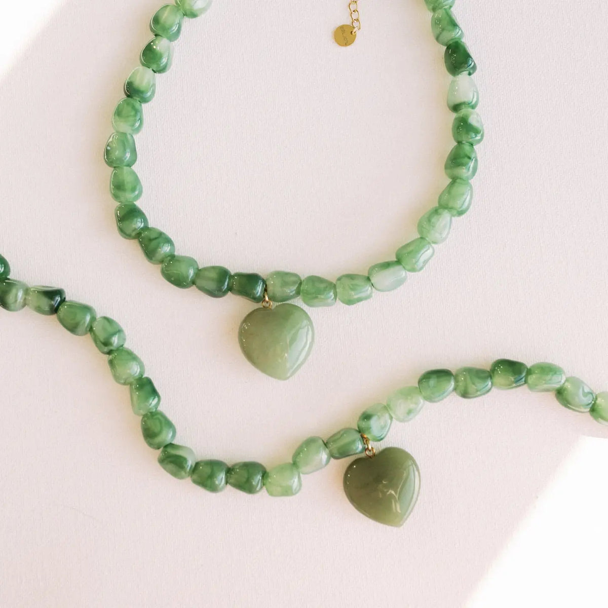 Green jade bead necklace with a matching heart-shaped pendant