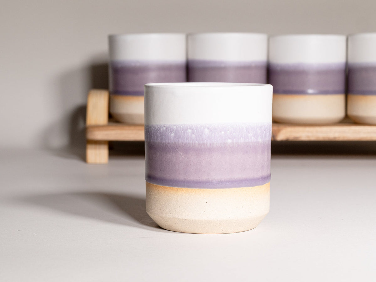 Stoneware smoothie cup with purple and beige ombre banding, white top rim
