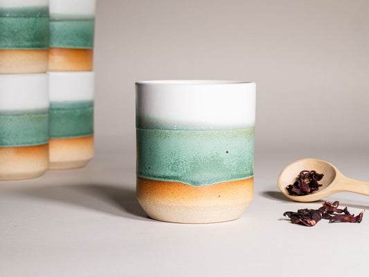 Green and white stoneware smoothie cup, 14 oz, with wide smooth rim.