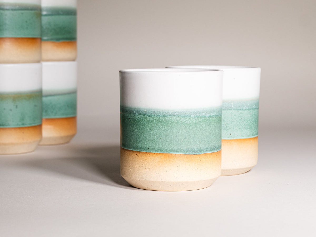 Green and white stoneware smoothie cup, 14 oz, angled view.