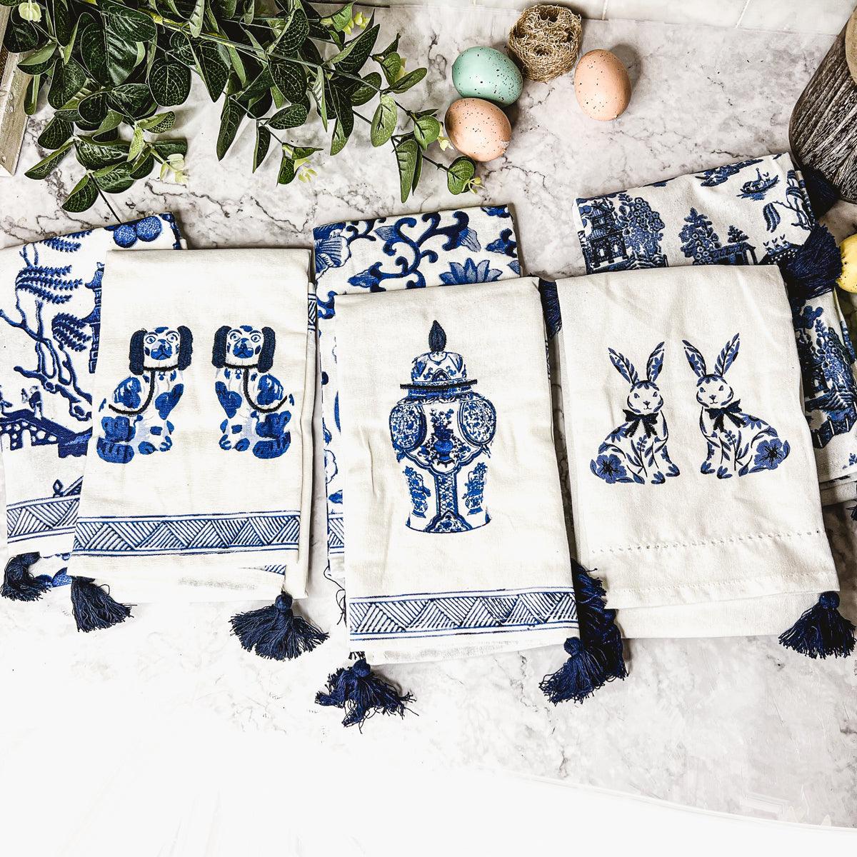 Cream and blue chinoiserie tea towels with urn, rabbit, and dog prints, navy tassels