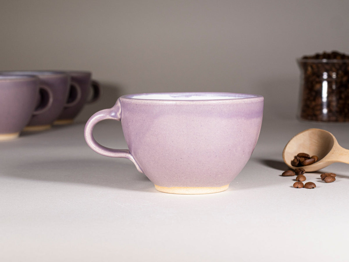 Purple stoneware latte cup with handle, glossy cream glaze at base, 10–12 oz