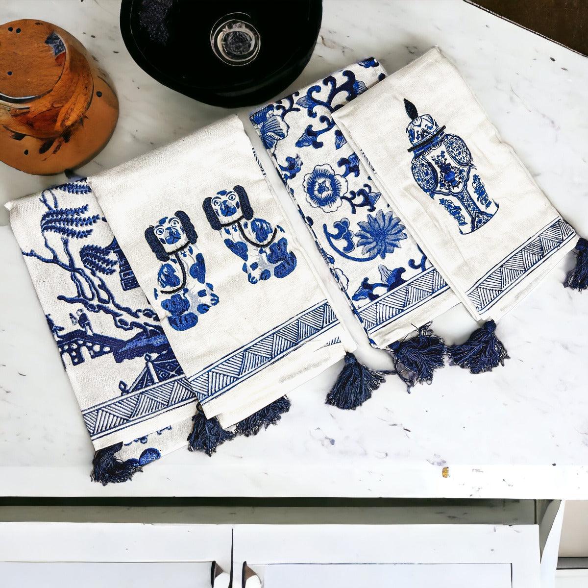 Set of blue-and-white chinoiserie tea towels, folded with hanging fringe tassels
