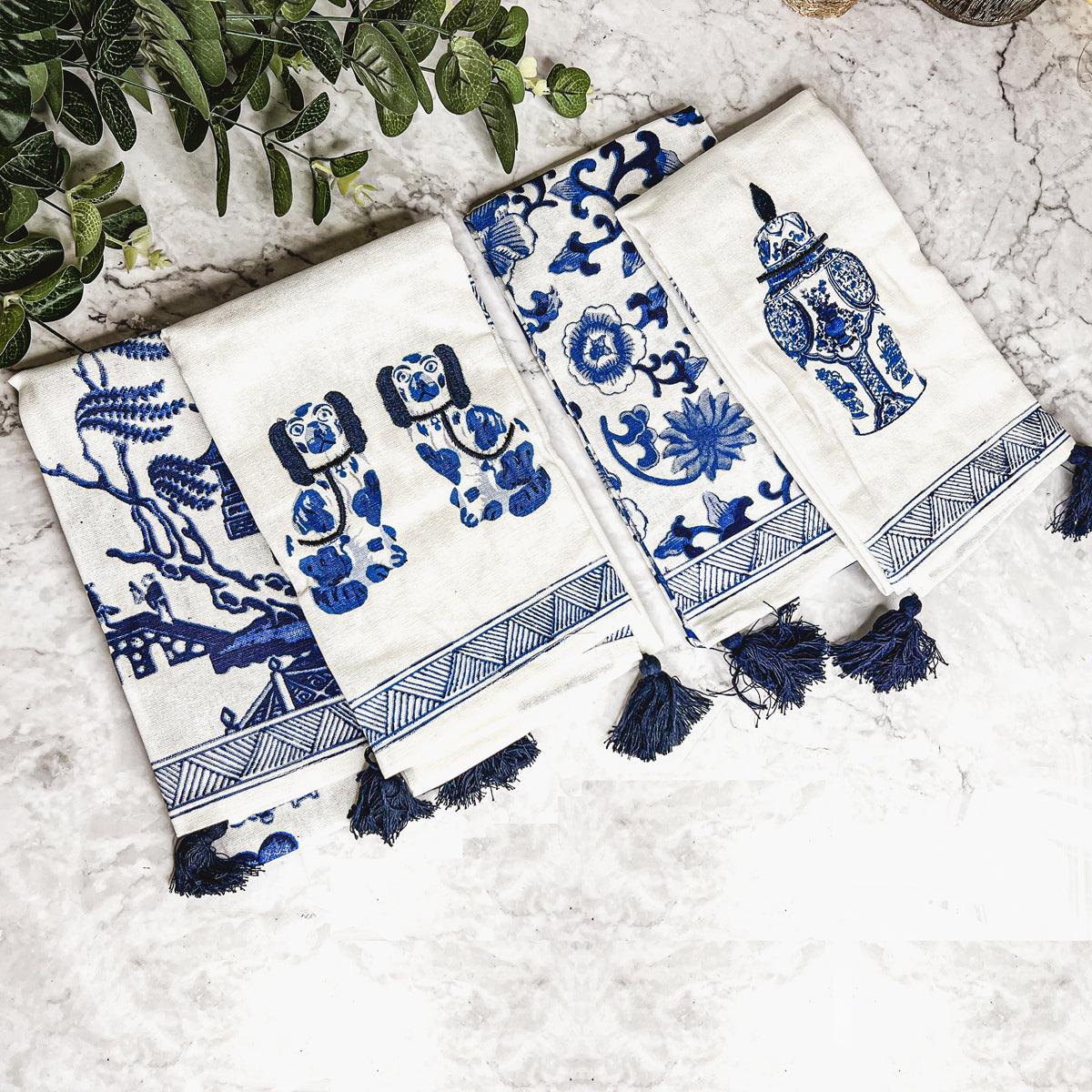 Blue-and-white chinoiserie tea towel set with bold motifs and dark blue fringe tassels