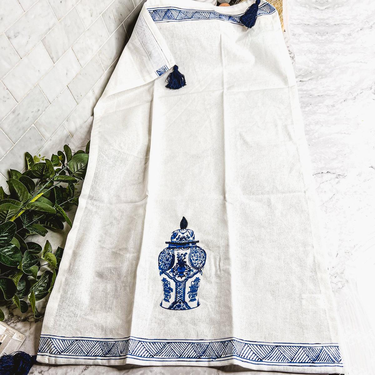 Chinoiserie tea towel with blue urn motif and blue striped hem, tassel fringe