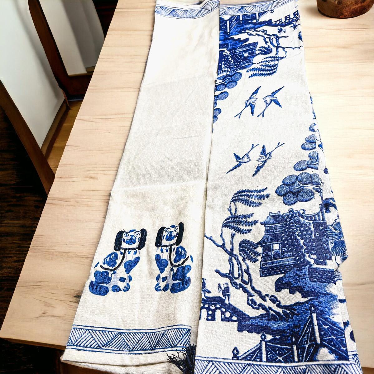 Blue-and-white chinoiserie tea towels with illustrated motifs and striped bottom border