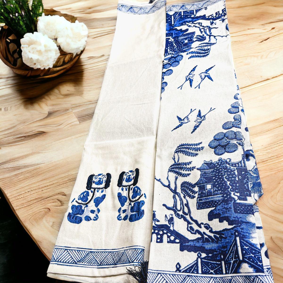 Chinoiserie tea towel with blue animal and landscape motifs, fringed border