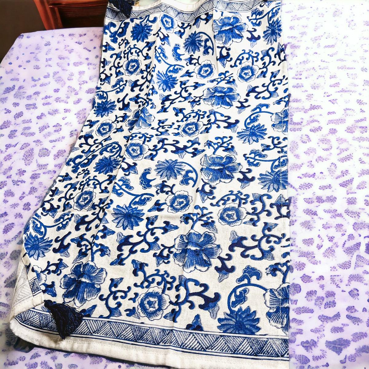 Blue-and-white chinoiserie printed tea towel with patterned border and fringe tassels