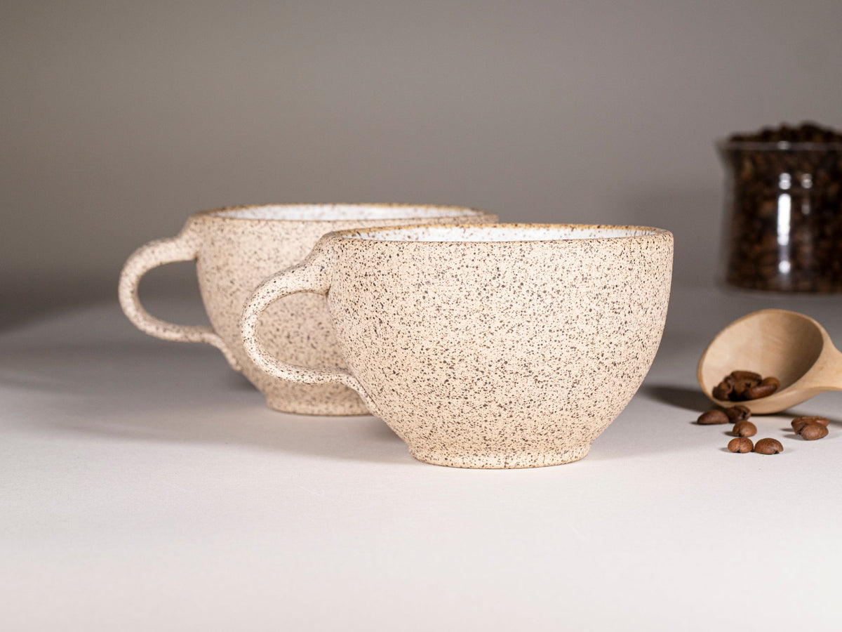 Speckled stoneware latte cup with handle and subtle speckle texture