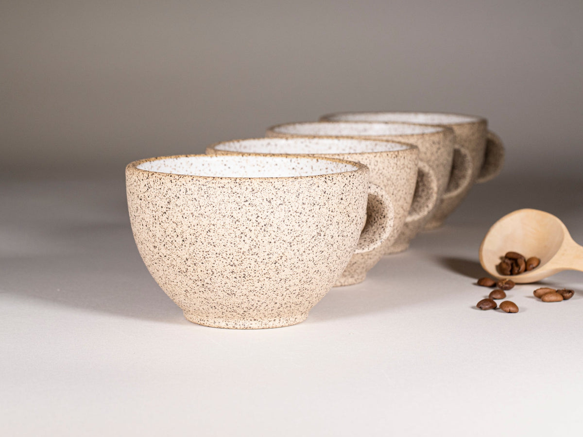 Speckled stoneware latte cup with handle, paired with another matching cup
