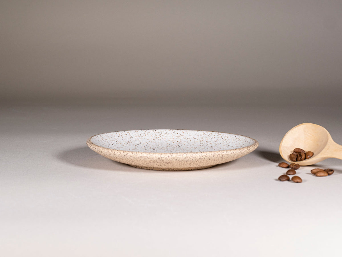 Speckled stoneware saucer plate for latte cup, shallow round shape