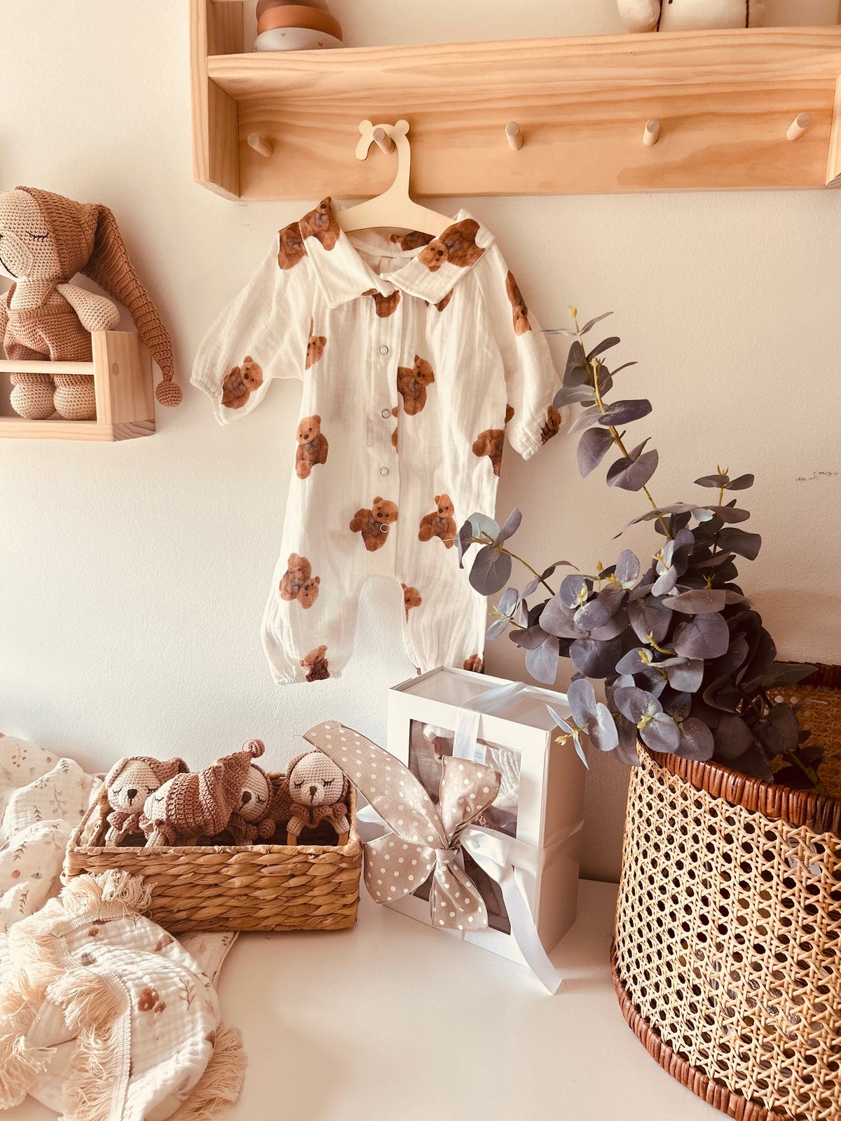 Bear-print baby romper with teddy bear rattle and woven gift display
