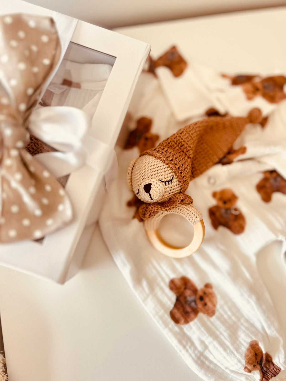 Teddy bear rattle and bear-print baby romper in a gift-ready box