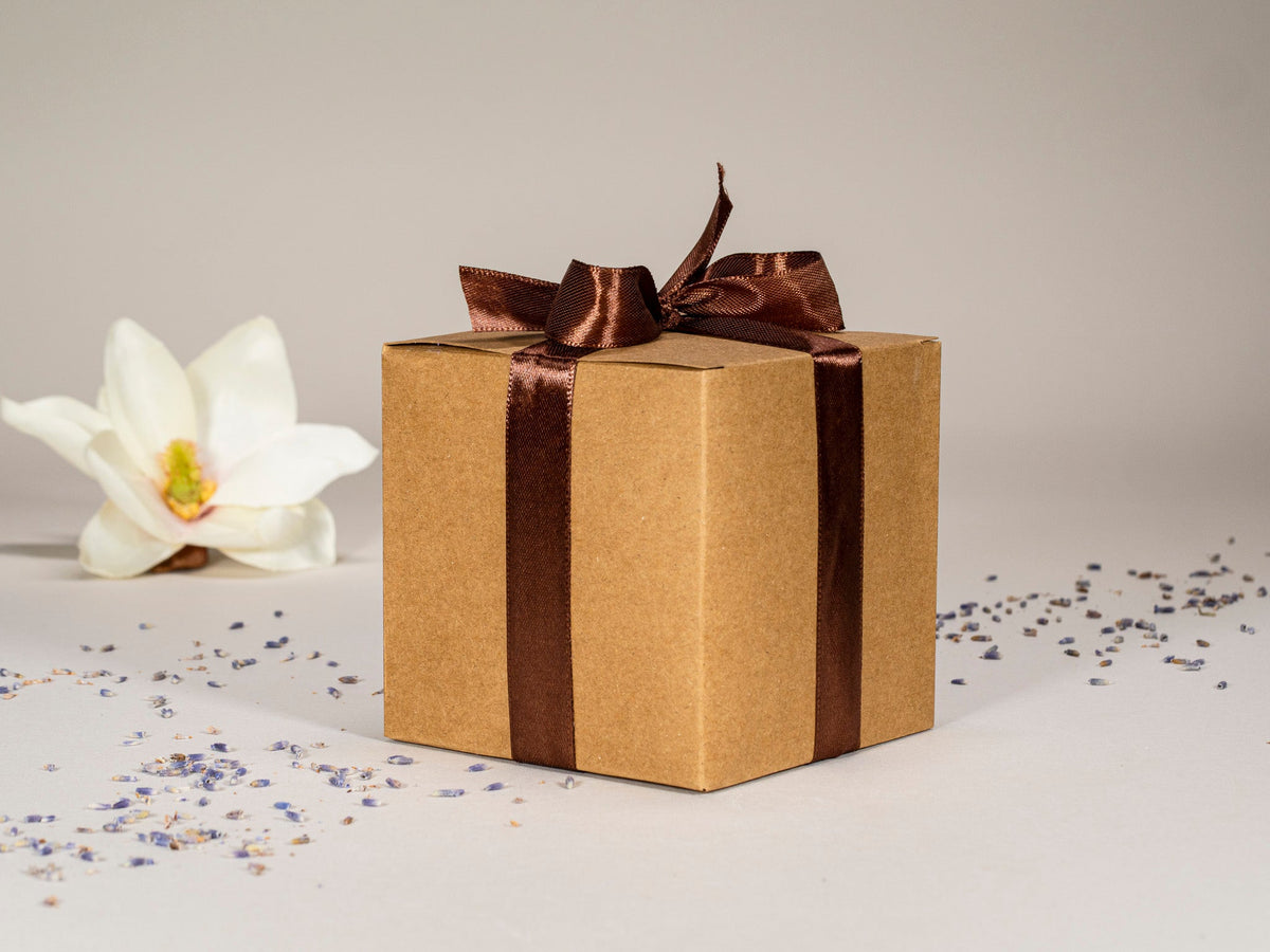 Gift box with brown ribbon and bow, cups not visible
